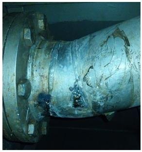 Corroded exhaust gas scrubber pipe section prepared for leak repair